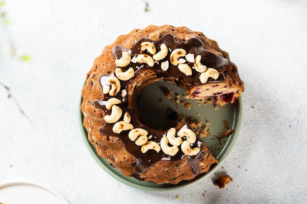 Bundt cake with nuts and chocolate on white background Top view of cake Festive cake New year cake with chocolate Christmas dessert