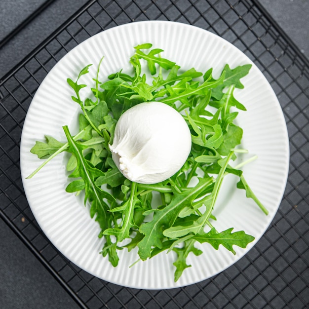 buratta salad arugula green leaves cheese burratina healthy meal food snack on the table copy space