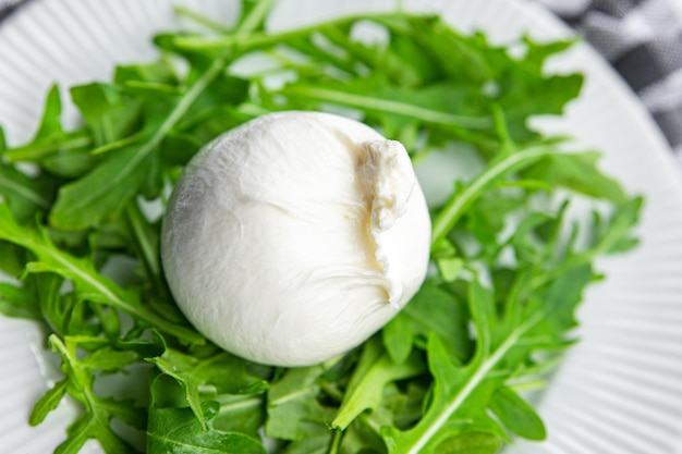 buratta salad arugula green leaves cheese burratina healthy meal food snack on the table copy space