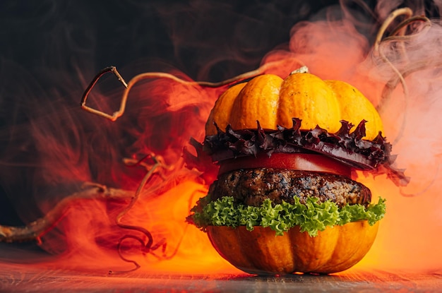 Burger Halloween halloween concept of a burger with big beef patties with pumpkin head rolls for the holiday halloween