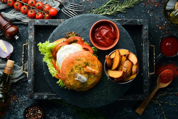 Burger with camembert cheese and meat French fries and ketchup Top view free space for your text Rustic style