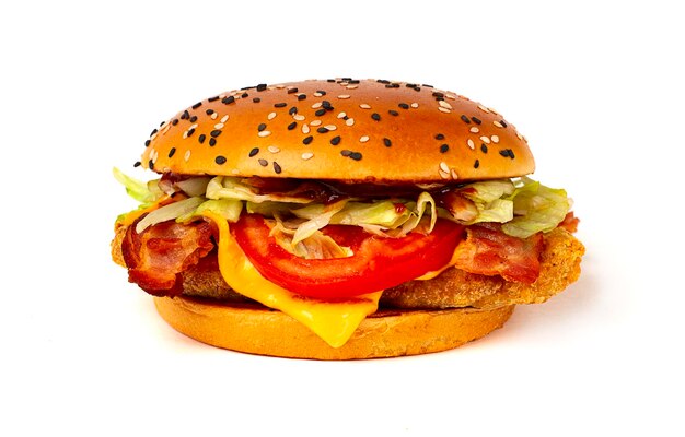 Burger with chicken cutlet with cheese fried bacon and vegetables on a white background no people