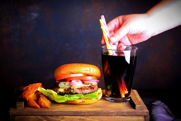 Burger with fried potatoes and fizzy drink