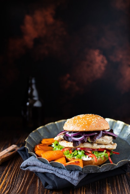 burger with grilled chicken fillet, paprika, sweet potato, lettuce, onions, and Greek yogurt