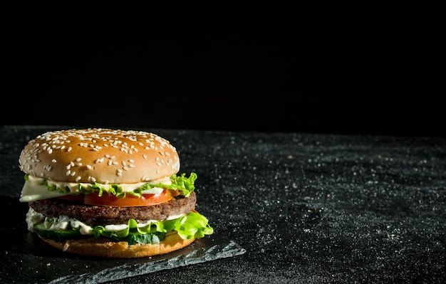 Burger with juicy beeftomatoes and salad