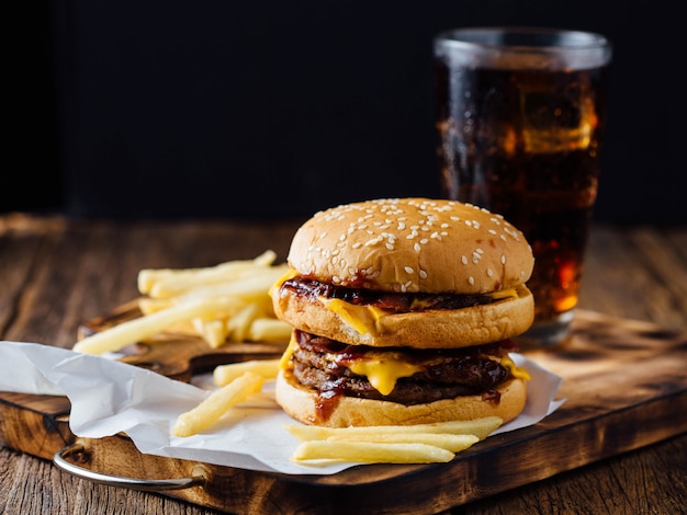 Burgers and French Fries on wooden table 