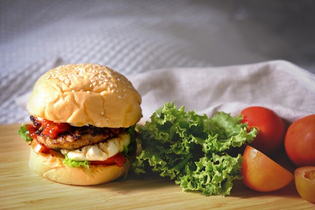 Burgers with cheese, salads and vegetables on a white space