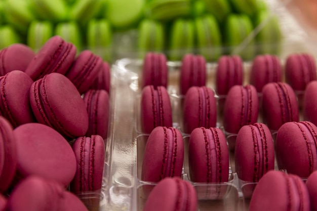 Burgundy and green macaroon cake on the counter Appetizing popular dessert Closeup