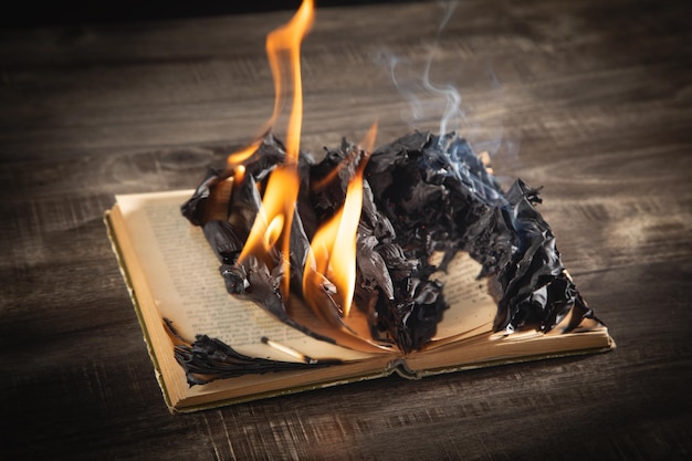 Burning book on the wooden table