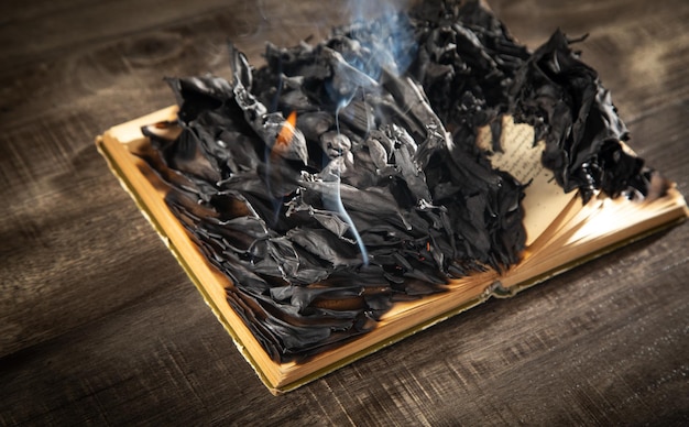 Burning book on the wooden table