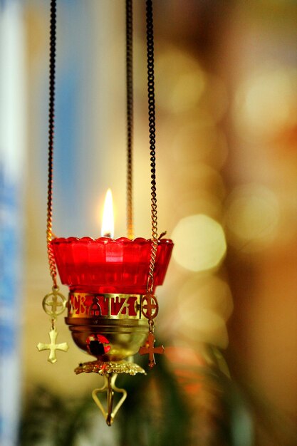 Burning candle in a church with the stainedglass window at the background Location New Zealand North Island Wellington