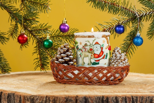 Burning candle cones and natural fir tree branches with Christmas balls