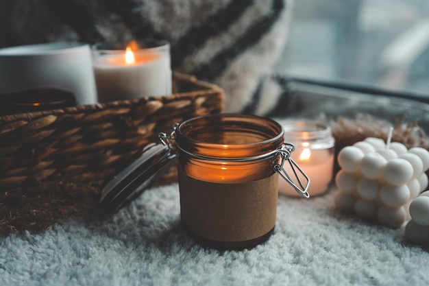 Burning candle in cozy home interior