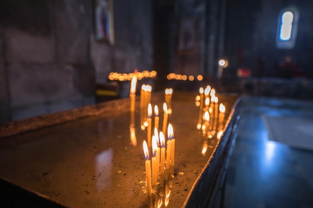 Burning candles in the church backgroundxA