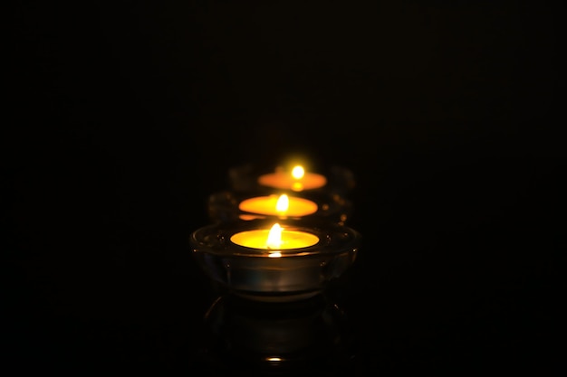 Burning candles on dark background