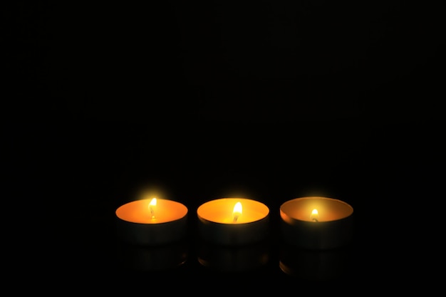 Burning candles on dark background