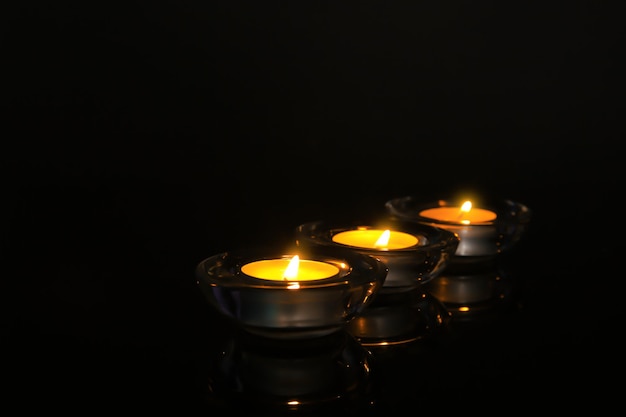 Burning candles on dark background