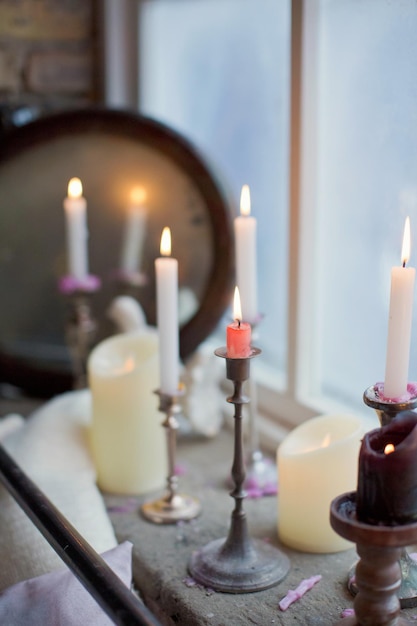 burning candles in silver candlesticks