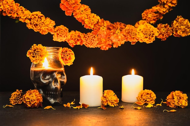 Burning candles Skull with marigold flowers and garlands Dia de los muertos day or day of the dead