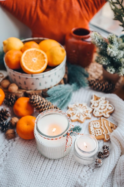 Burning candles on the windowsill in the New Year's decor atmospheric aesthetic photography