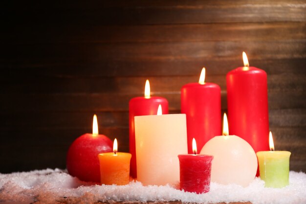 Burning candles on wooden background