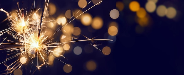 Burning Christma sparkler with bokeh background. Merry Christmas and happy new year background.