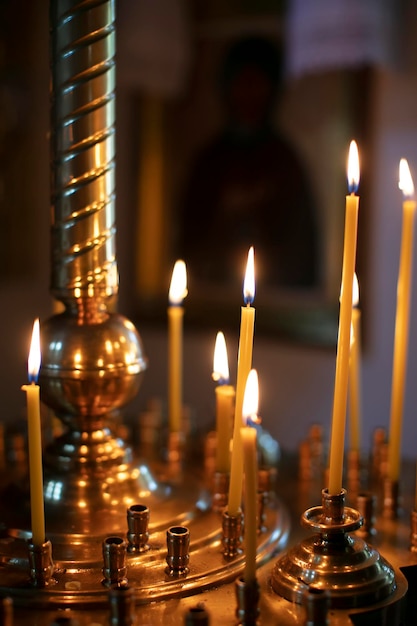 Burning church candles on a dark background Christian symbol