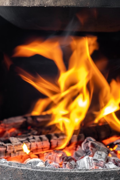 Burning coals in a metal grill for frying meat and vegetables