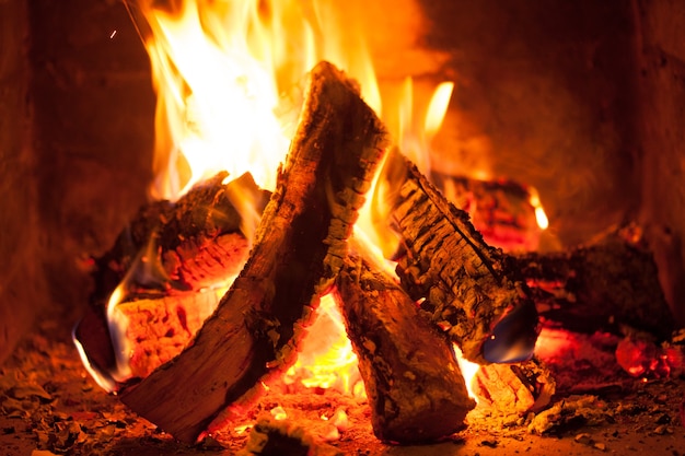 Burning fire in the brick fireplace, close up