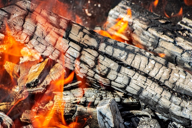 Burning firewood and coals in the grill. Burning fire. Grilling meat. Coals for frying.