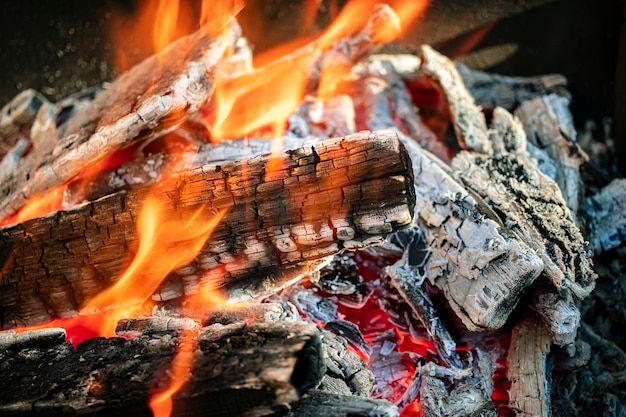 Burning firewood and coals in the grill. Close-up. Macro shooting. Burning fire. Grilling meat.