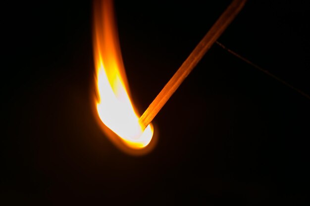 Photo burning match in the dark close up view