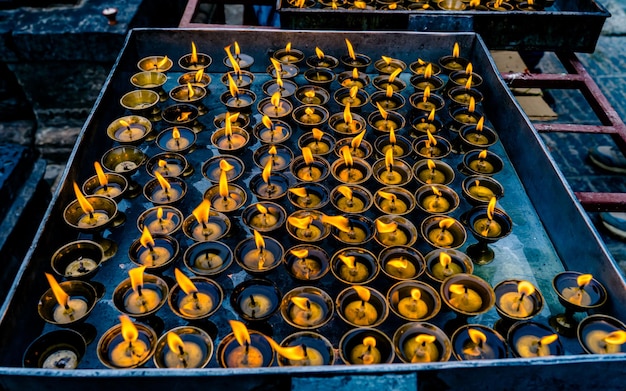 burning oil candle during praying at Baudhanath stupa at Kathmandu, Nepal.