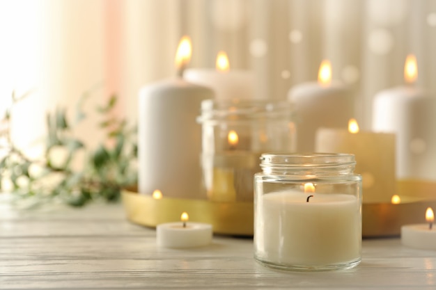 Photo burning scented candles for relax on white wooden table