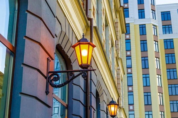 Burning shaped lamps on the wall of the building.