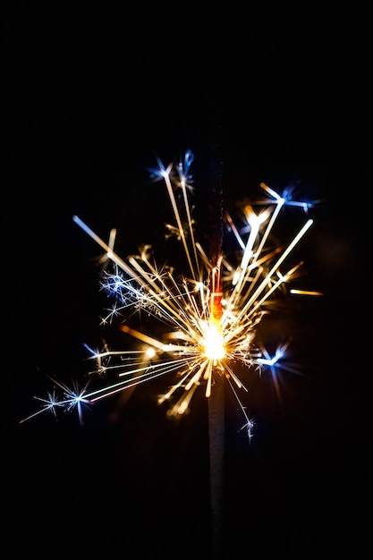 Burning sparkler isolated on black background blur