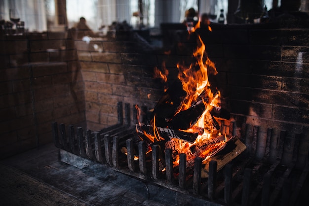 Burning woods with bright flame and sparks against dark background