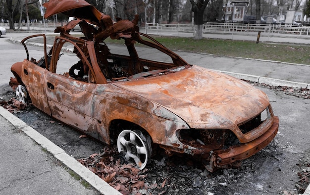 Burnt damaged car of a civilian during the war Russians against the Ukrainian people genocide