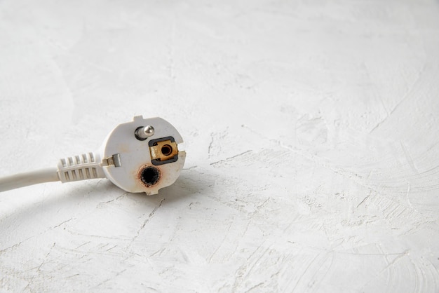 Burnt European plug type F As a result of a short circuit one contact burned out