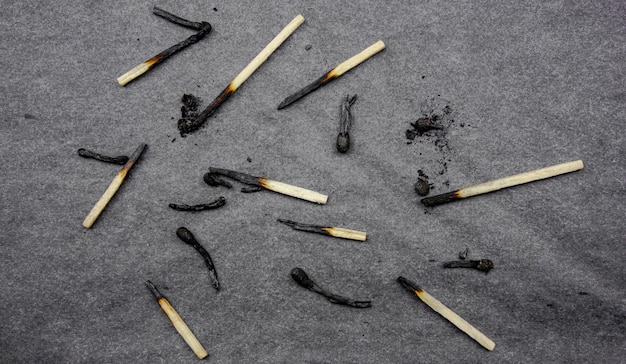 Burnt matches on a dark background Burnt wooden matches