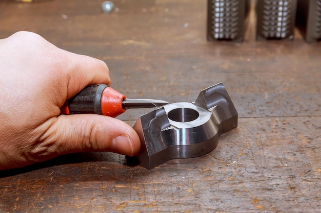 Burr removal tool for metal wood aluminum copper and plastic The worker removes burrs from the metal