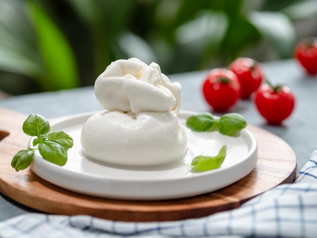 Photo burrata cheese on plate copy space gray background