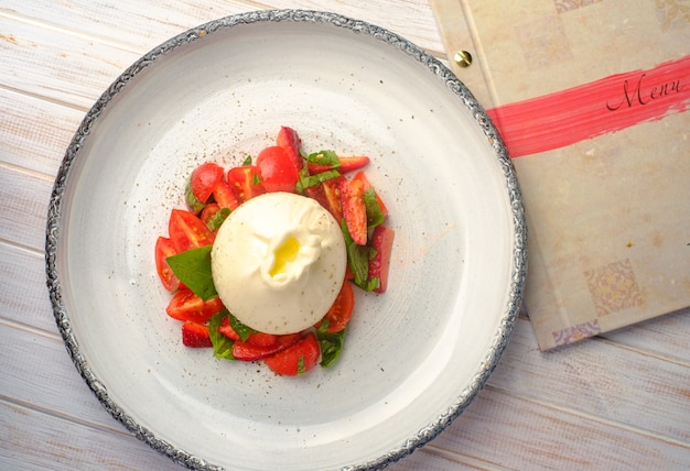 Burrata cheese with strawberries in plate