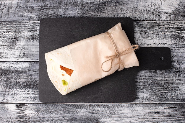 Burritos shawarma with meat on a white wooden background