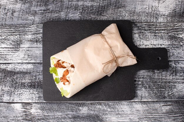 Burritos shawarma with meat on a white wooden background