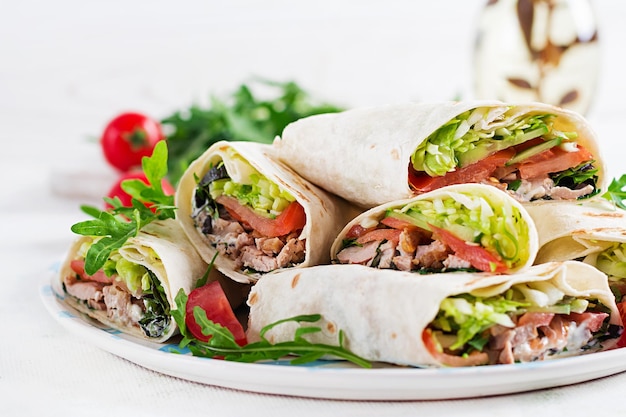 Burritos wraps with beef and vegetables on light background Beef tortilla mexican food