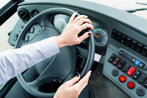 Bus driver in cockpit at the wheel driving