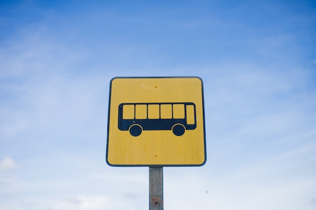 bus stop sign with blue sky background