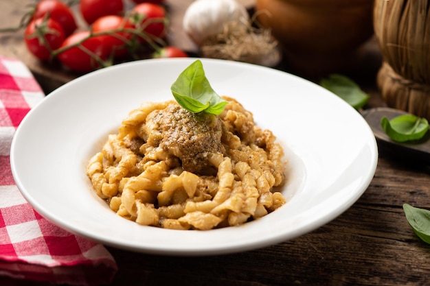 Busiate Pasta with red pesto sauce, pesto Trapanese. Close up