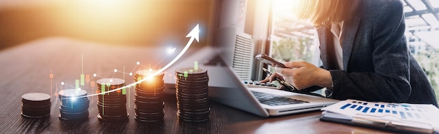 Business accountant working on desk using mobile phone and calculator to calculate budget concept finance and accounting in morning light